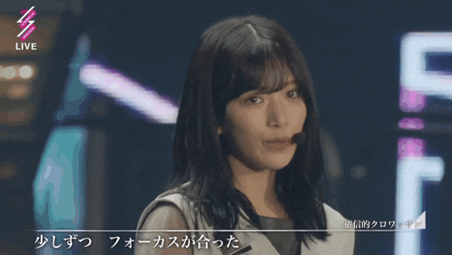 a woman singing into a microphone with the word live in the upper right corner
