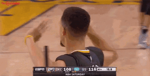 a basketball player with the number 30 on his back is raising his arms in the air