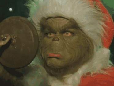 a close up of a grinch 's face with a santa hat on