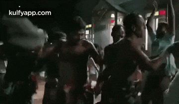a group of people are dancing in a dark room in a dark room .