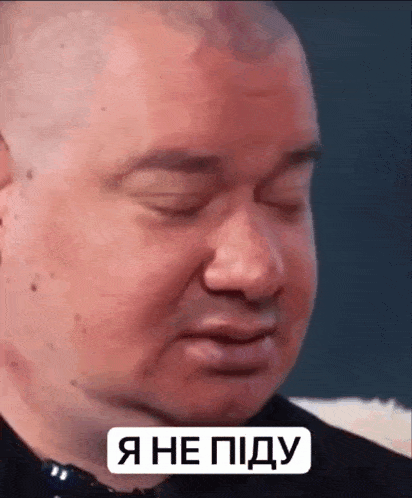 a close up of a man 's face with his eyes closed and a sign that says i 'm not a dog