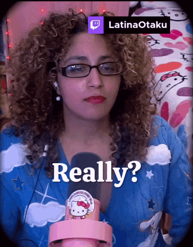 a woman with curly hair is wearing glasses and a hello kitty shirt and says really