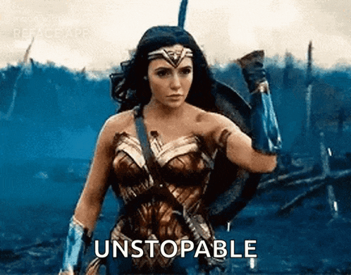 a woman in a wonder woman costume is holding a shield and a sword and says `` unstoppable '' .