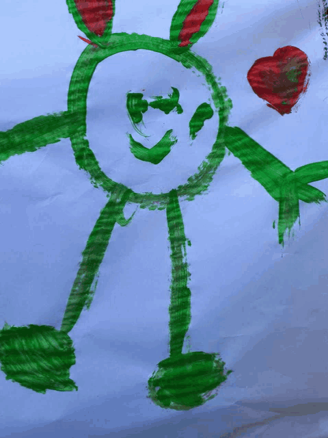 a child 's drawing of a green frog with a red heart