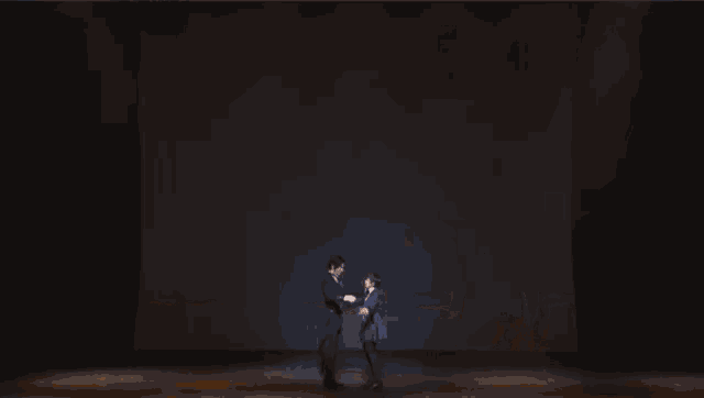 a man in a tuxedo is dancing with a woman in a blue dress