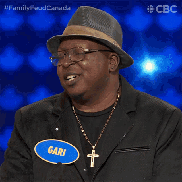a man wearing glasses and a hat has a name tag that says gari
