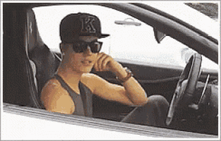 a man wearing a baseball cap with the letter k on it