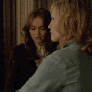 two women are standing next to each other and one of them is wearing a blue jacket