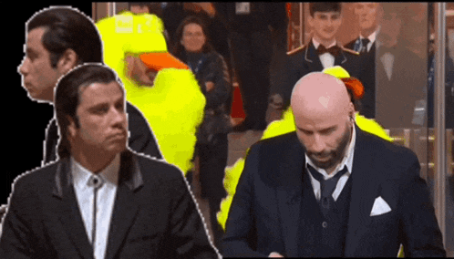 a bald man in a suit stands next to another man in a yellow costume
