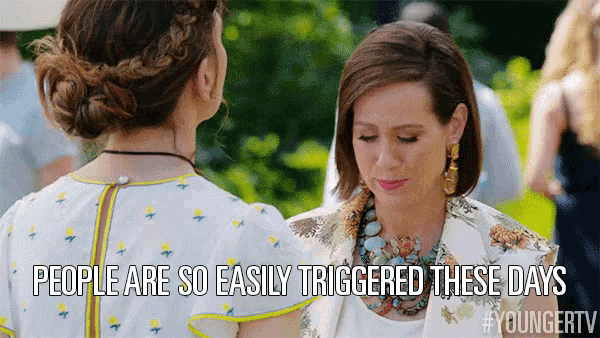 two women are standing next to each other and the caption says people are so easily triggered these days .