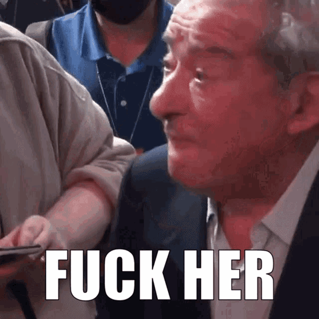 a man in a suit says fuck her in a crowd