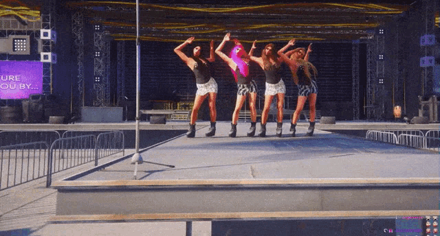a group of women are dancing on a stage in front of a sign that says lure you by