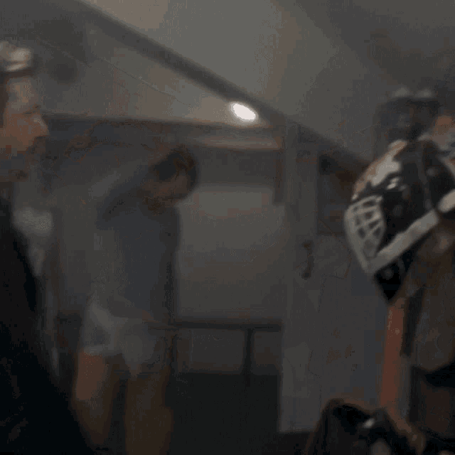 a man wearing a hockey helmet is holding a hockey stick