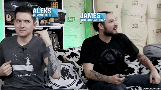 two men are sitting on a couch and one of them has the name james on it
