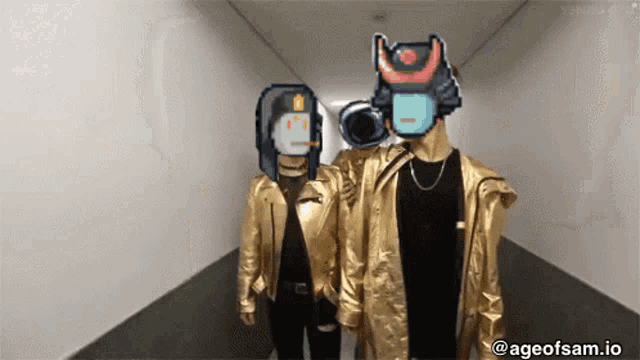 two people in gold jackets are standing in a hallway with ageofsam.io written on the bottom right
