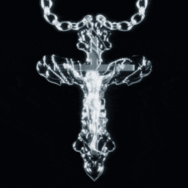 a silver cross with jesus on it is hanging from a chain