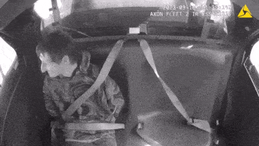 a black and white photo of a man in a car that says axon fleet on it