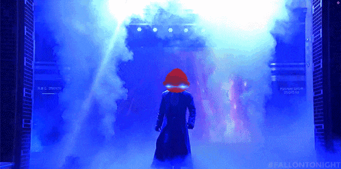 a man in a trench coat is standing in front of a stage with smoke coming out of it and the hashtag #fallontonight