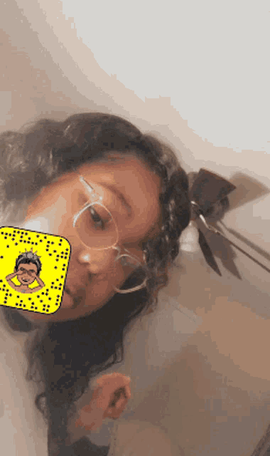 a girl wearing glasses and a snapchat filter