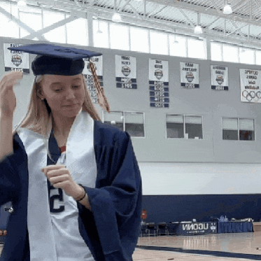 a girl in a graduation cap and gown with the number 2