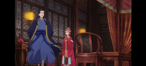 a woman in a blue cape is standing in a room with two other people