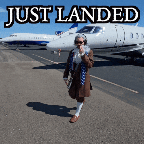 a man is standing in front of a plane with the words just landed above him