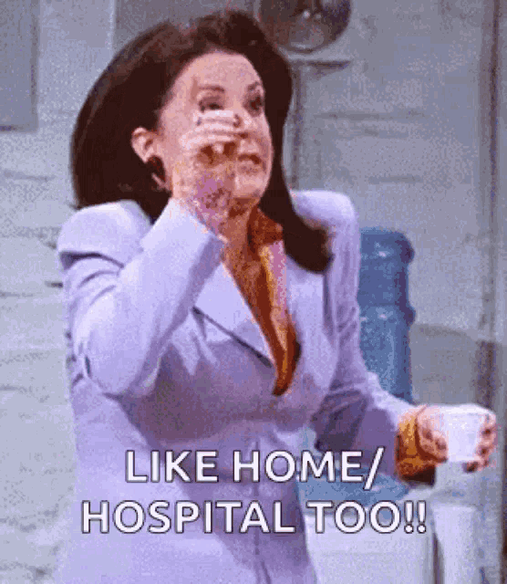 a woman in a purple suit is saying like home / hospital too