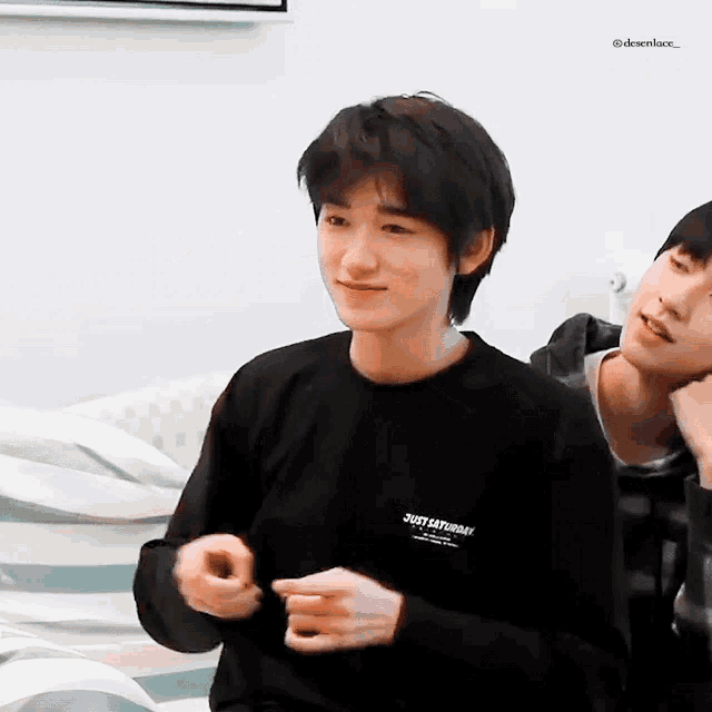 a boy wearing a black shirt that says just saturday