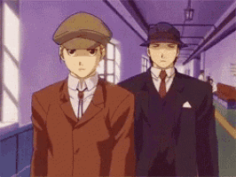 two men in suits and hats are standing in a hallway