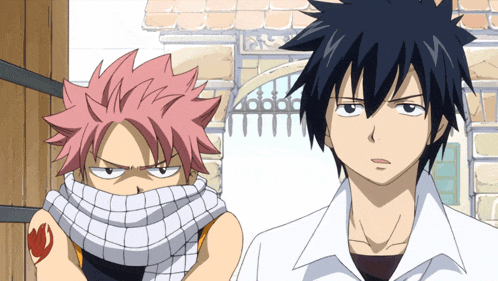 a man with a scarf around his neck is standing next to another man with a scarf around his neck
