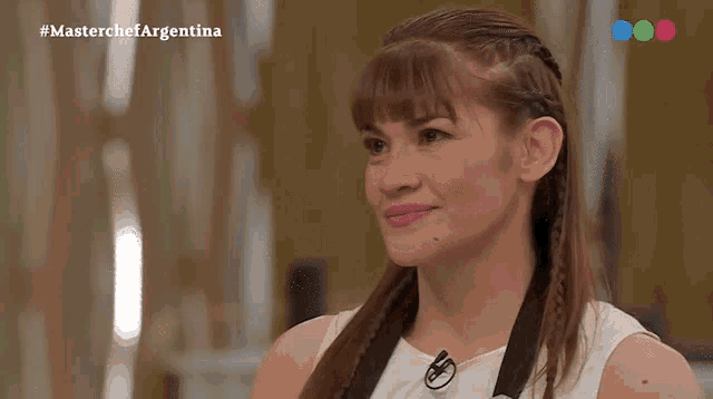 a woman in a white dress is on a masterchef argentina show