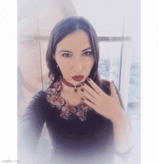 a woman wearing a choker necklace and red lipstick takes a selfie