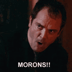 a man in a suit and tie is screaming with the word morons written below him