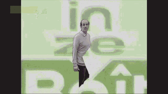 a man stands in front of a sign that says " in zone boite "