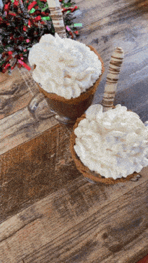 two mugs of hot chocolate with whipped cream on top