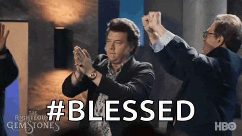 a group of men are clapping their hands in the air with the word blessed above them