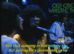 a group of people singing in front of an old grea whistle sign