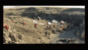 a group of men in red uniforms are standing in a field