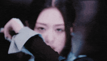 a close up of a woman 's face with a blurred background