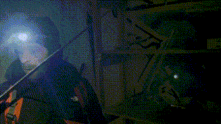 a person is holding a long stick in a dark room .