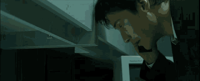 a man talking on a cell phone in an office cubicle