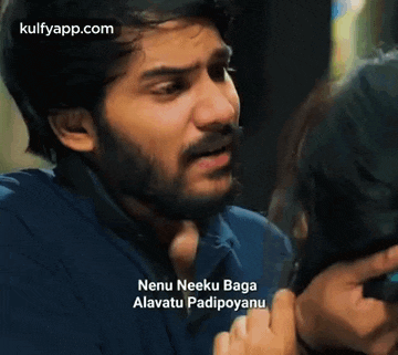 a man with a beard is talking to a woman while holding her hair .