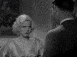 a man and a woman are standing next to each other in a room .
