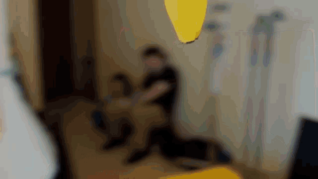 a blurry picture of a person sitting on a bed
