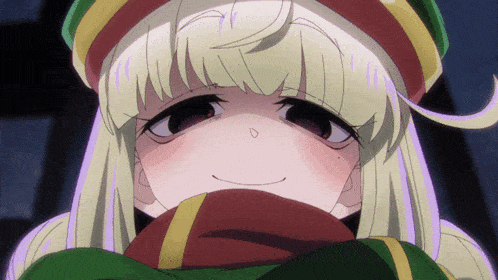 a girl with blonde hair and a scarf around her neck looks at the camera
