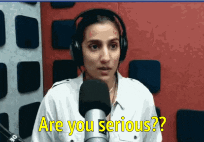 a woman wearing headphones is talking into a microphone and says are you serious