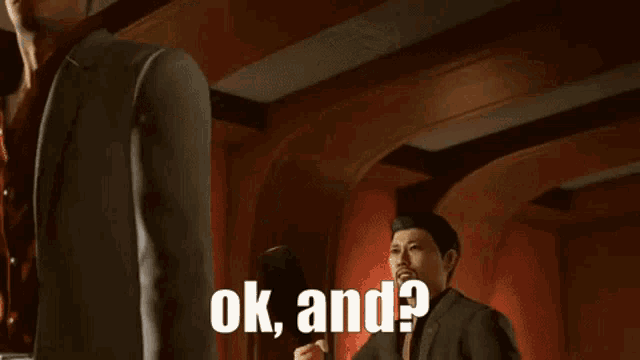 a man in a suit is holding a bottle in his hand and says ok and