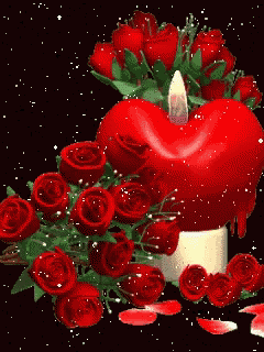a red heart shaped candle is surrounded by red roses