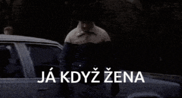 a man walking down a street with the words ja kdyz zena on the bottom right