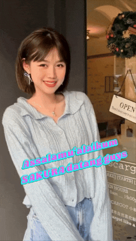 a woman standing in front of a sign that says open on it